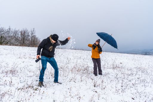 A couple playing with snowballs at a park during winter in the town of Opakua near Vitoria in Araba, Basque Country. Spain