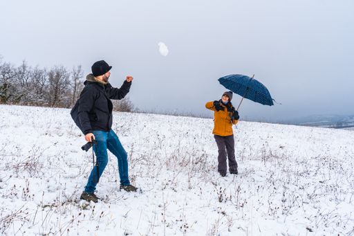 A couple playing with snowballs at a park during winter in the town of Opakua near Vitoria in Araba, Basque Country. Spain