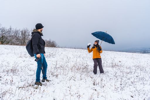 A couple playing with snowballs at a park during winter in the town of Opakua near Vitoria in Araba, Basque Country. Spain