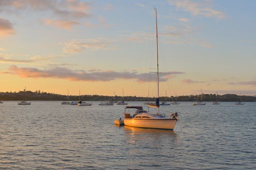 View of small yacht in sunset light at Bucklands Beach (Tamaki River) on new 2021 year eve