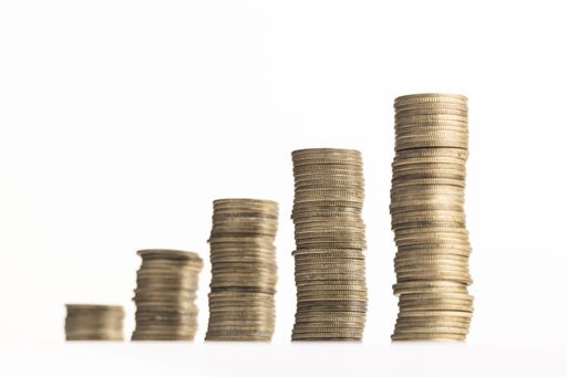 Rising stack of coins isolated on a white background. Growth, income, savings, investment concept. Copy space