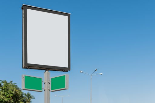 A small blank billboard with space for text under a blue sky - perfect for advertisement background