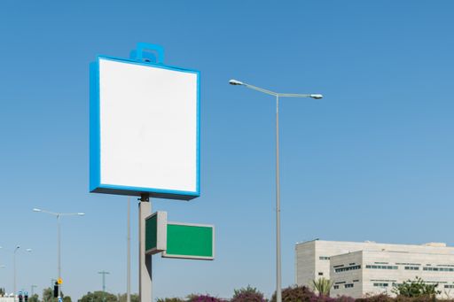 A small blank billboard with space for text under a blue sky - perfect for advertisement backgrounds