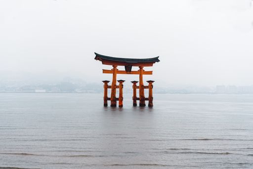The Torii Gate standing in the water near the island of miyajima in Japan.