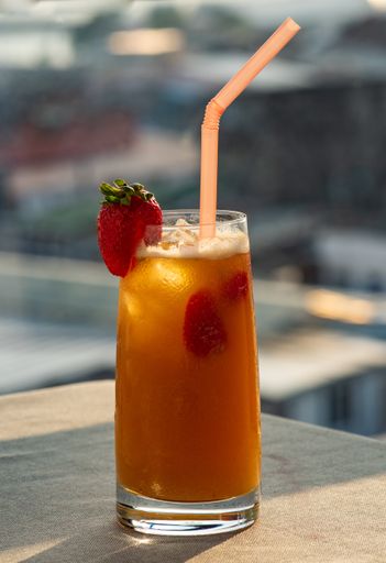 A vertical selective focus shot of a non-alcoholic drink on blurred background