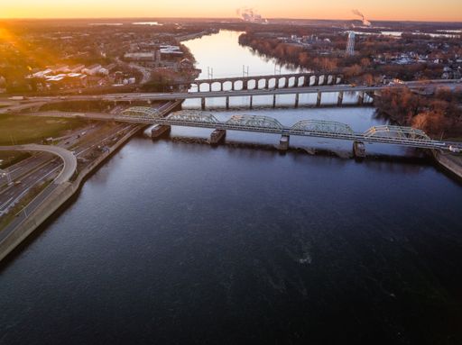 An aerial of the intersection of the Lower Trenton bridge and a highway bridge in Trenton at sunrise