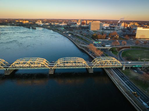 An aerial of the Lower Trenton highway bridge over the Delaware river in Trenton, New Jersey at sunrise