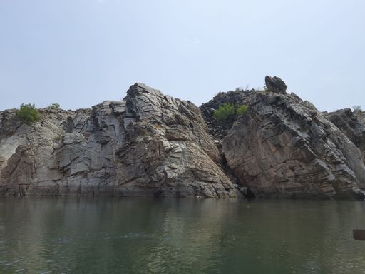 A beautiful nature scene with the cliffs and lake under a blue sky