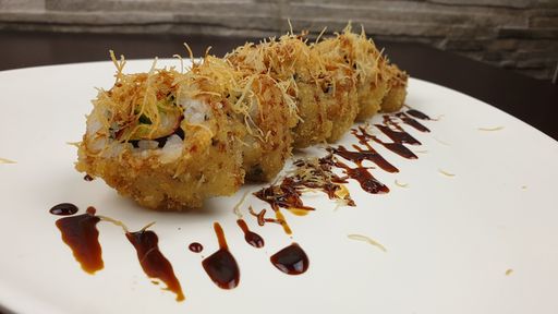 A closeup shot of sushi rolls in a Japanese restaurant served on a white plate