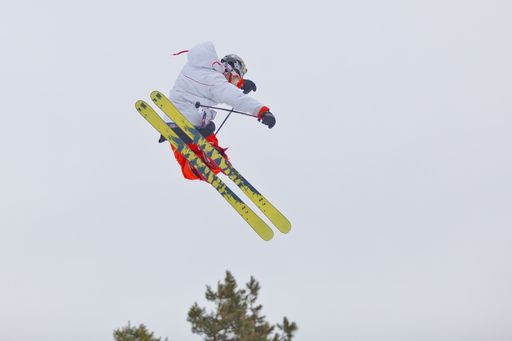 A skier making a high jump in the air
