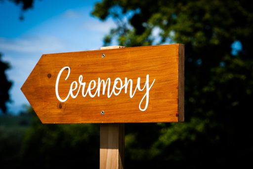 A selective focus shot of a wooden sign with the text "ceremony"