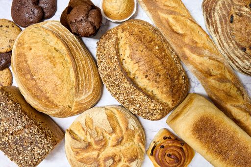 A closeup of an assortment of freshly baked bread on a marble table