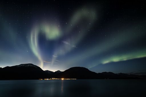The Hear-shaped polar aurora lights in  starry sky in Lyngenfjord, Norway
