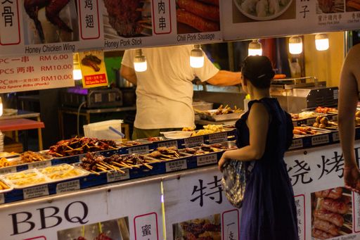 Woman buys food at stall