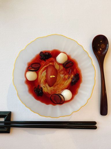 A plate of Asian-style food, complete with chopsticks, is arranged in an unusual way