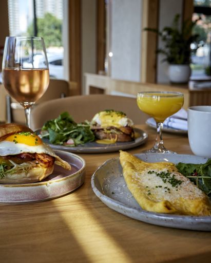 A vertical shot of a table full of delicious dishes ready for a brunch