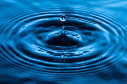 A falling droplet of water with circular waves