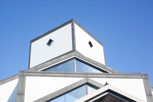 A low angle shot of the top of Suzhou museum's architecture against blue sky