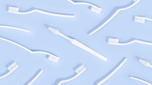 A top view of plane white toothbrushes on a light blue pastel surface