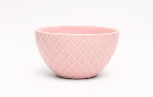 A closeup shot of an empty pink bowl on a white background
