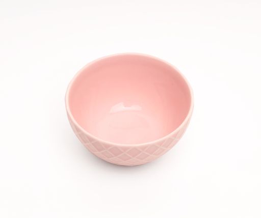 A closeup high angle shot of an empty pink bowl on a white background