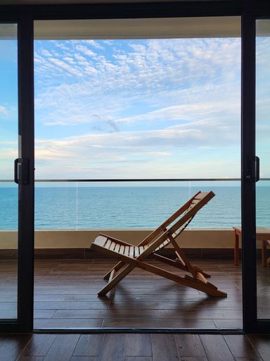 holiday picture of a deck chair with sea view
