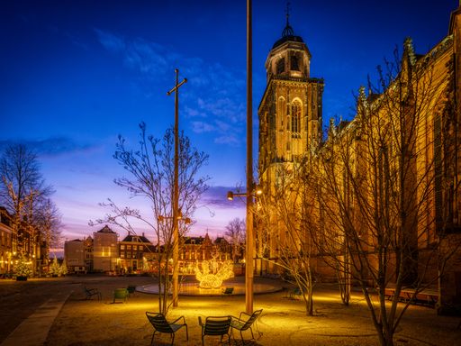 A beautiful view of the Lights on the old church square in Deventer during nightfall time in Netherlands