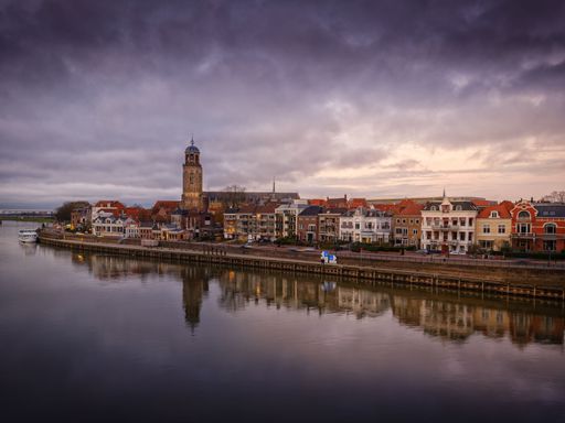 The cityscape of the river city Deventer, Netherlands with a view of St Lebuinus church on a cloudy day