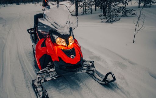 A red Ski-Doo Snowmobile on the street on a cold snowy day, Rovaniemi, Finland