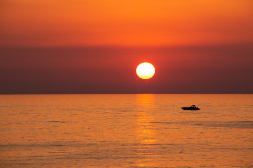 A breathtaking sunset scenery with the orange sky over the pure sea