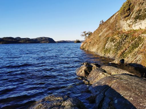 A beautiful view of the Farris lake surrounded by rocky cliffs in Larvik, Norway