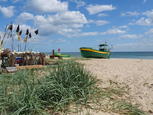 A stunning view of the Baltic Sea in Gdynia, Poland, featuring a picturesque harbor, lush trees, and abundant natural beauty
