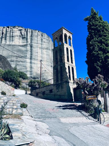A vertical shot of a tower of an ancient Byzantine church located in Meteora, Greece