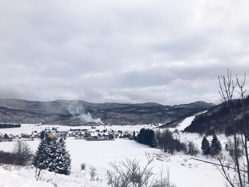 A beautiful winter landscape of a small village surrounded by mountains