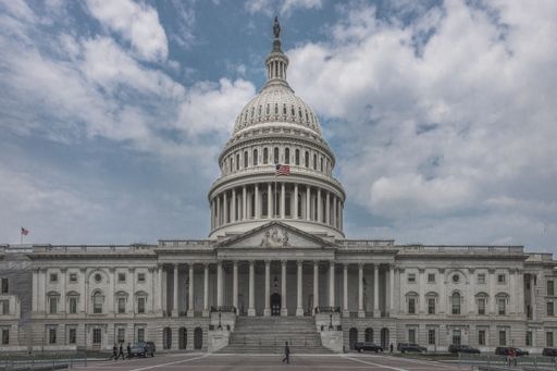 A horizontal view of the U.S. Capitol Building in Washington America under the blue clouded sky