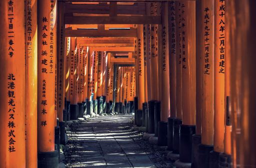 The Red Torii gates with writing on it in Fushimi Inari shrine in Kyoto, Japan