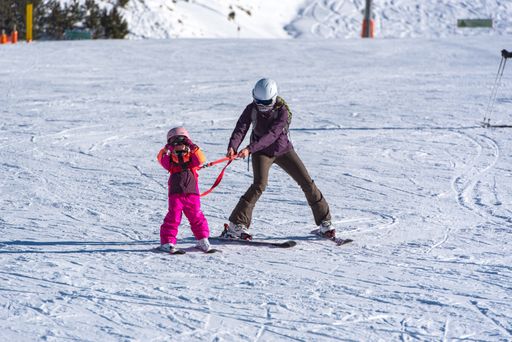 Pas de la Casa, Andorra: January 3, 2021: Mother with her Child skiing in the Pyrenees at the Grandvalira ski resort in Andorra in time of Covid19