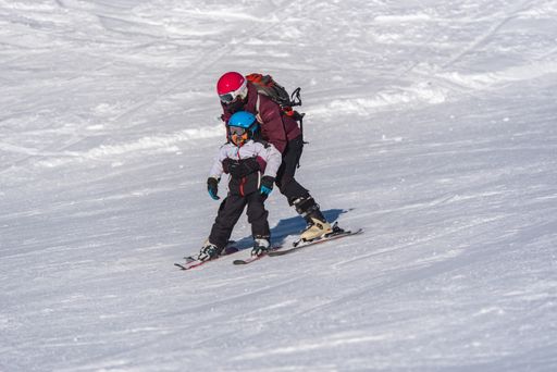 Pas de la Casa, Andorra: January 3, 2021: Mother with her Child skiing in the Pyrenees at the Grandvalira ski resort in Andorra in time of Covid19
