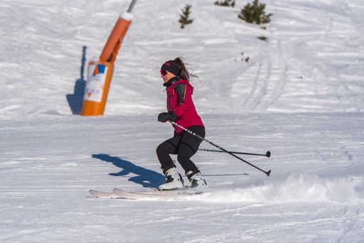 Pas de la Casa, Andorra: January 3, 2021: Young woman skiing in the Pyrenees at the Grandvalira ski resort in Andorra in Covid19 time