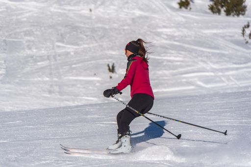 Pas de la Casa, Andorra: January 3, 2021: Young woman skiing in the Pyrenees at the Grandvalira ski resort in Andorra in Covid19 time