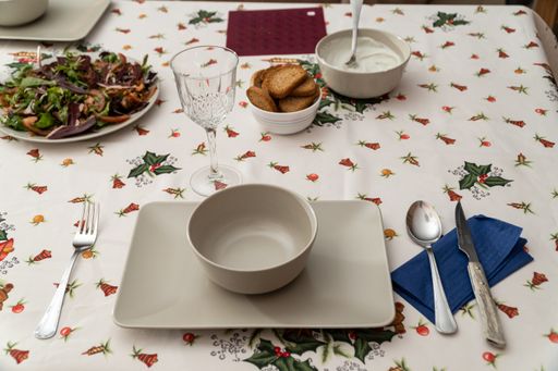 A high angle shot of a dinner table with empty dishes and meat and sauce