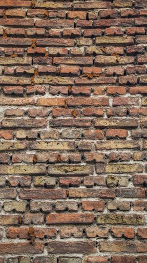 old brick wall of a european house in the city. old facade
