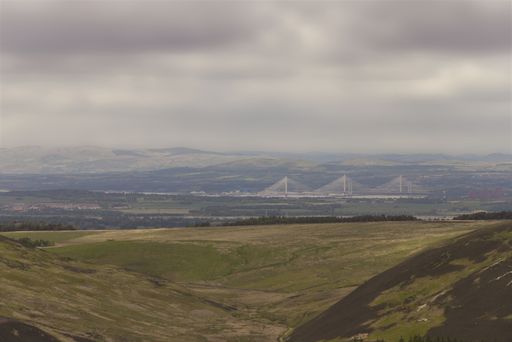 A scenic mountainous landscape with a bridge in the background. Queensferry, UK.
