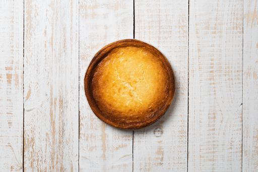 A top view of a whole delicious homemade pie on a wooden table