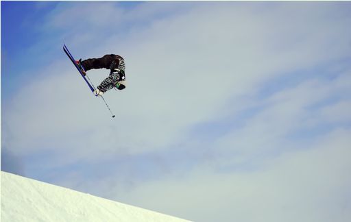 A professional skier making a high jump in the air