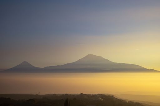 A beautiful shot of a lake with a mountain in the background during the sunset on Yerevan-Garni road in Armenia