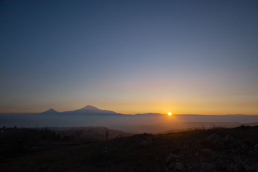 A beautiful shot of a lake with a mountain in the background during the sunset on Yerevan-Garni road in Armenia