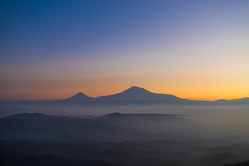 A beautiful shot of a lake with a mountain in the background during the sunset on Yerevan-Garni road in Armenia