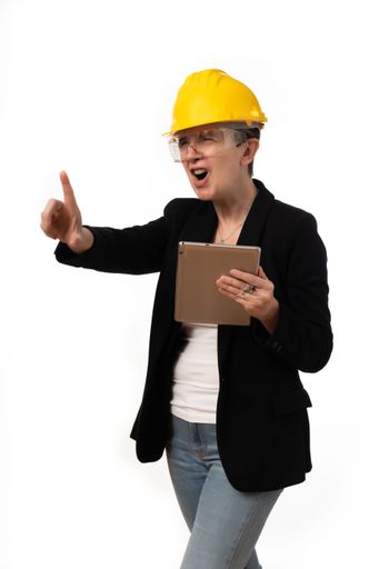 An engineer woman angrily holding a tablet on white background