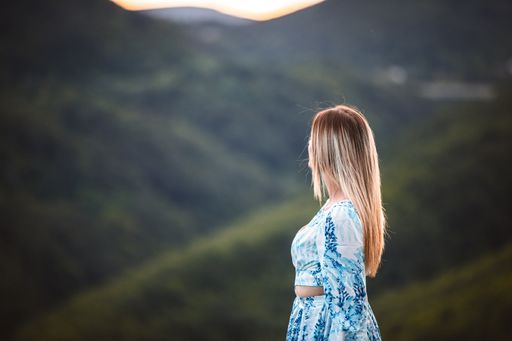 A young female standing near the hills